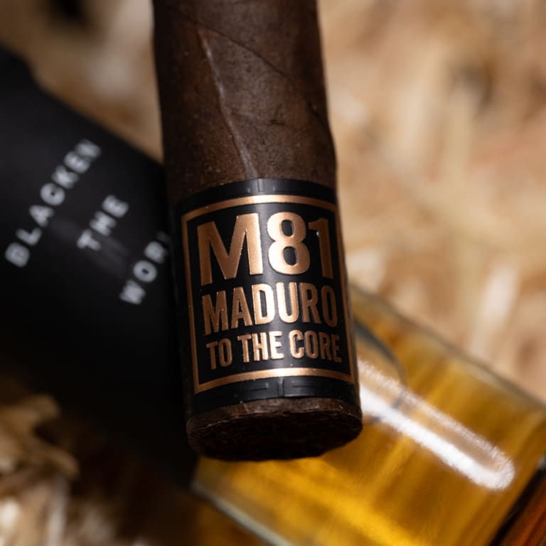 A close-up of a blackened maduro cigar