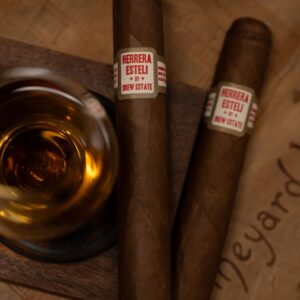 2 herrera esteli habano cigars by a glass of whiskey