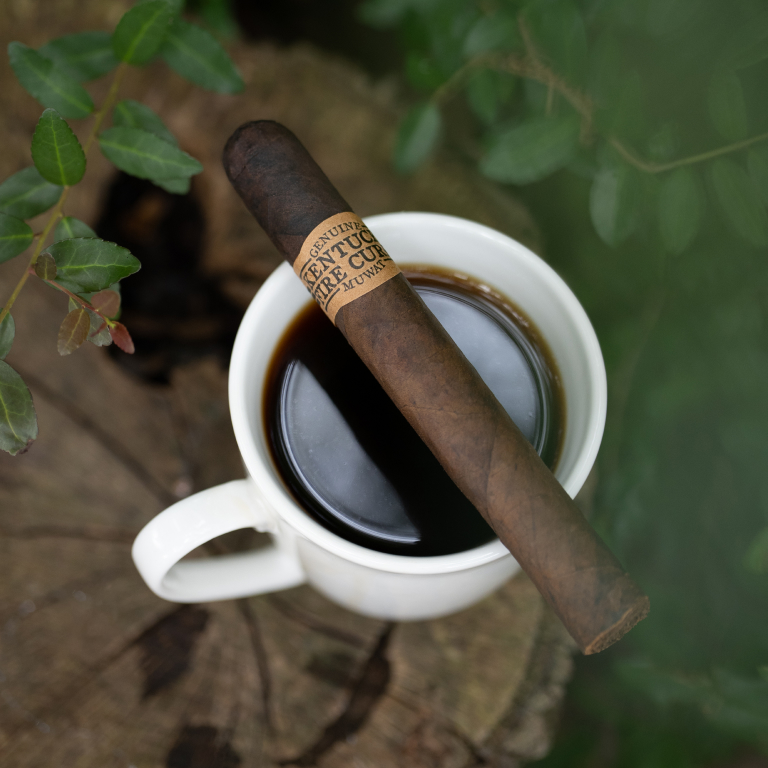 kentucky fire cured original cigar laying on a cup of coffee