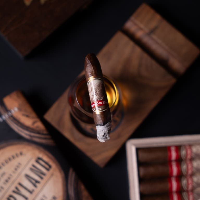 A Pappy Van Winkle traditional cigar resting elegantly on a polished wooden table