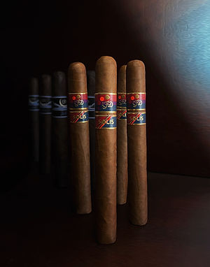 A row of La Flor Dominicana cigars standing with visible Solis bands on the front cigars against a dark wood background.