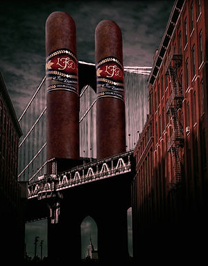 Stylized image of two La Flor Dominicana cigars with LFD bands between buildings