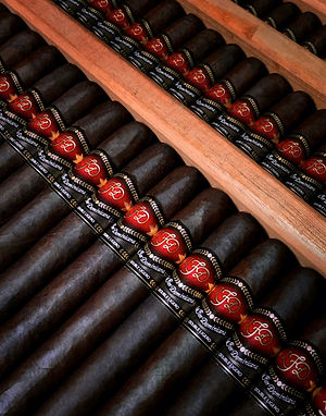 Close-up of La Flor Dominicana cigars with red LFD bands in wooden trays