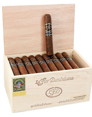 Open wooden box of La Flor Dominicana Colorado Oscuro cigars with one cigar standing upright