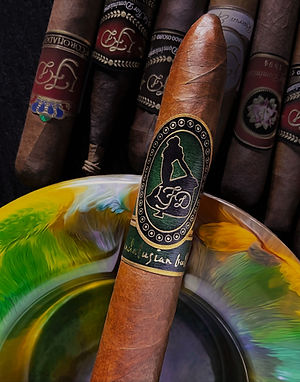 Close-up of an Andalusian Bull cigar showing the green band with logo and surrounding cigars