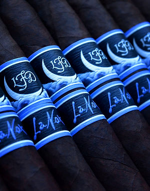 Close-up of La Flor Dominicana La Nox cigar bands showing LFD logo and 'La Nox' script on blue bands.