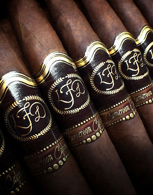 Close-up of La Flor Dominicana Cameroon Cabinet cigars showing LFD monogram bands and the 'Cameroon Cabinet' band