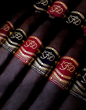 La Flor Dominicana Chapter I and Capitulo II cigars with red and black LFD bands reading 'Chapter One' and 'Capitulo I'.