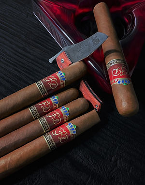 La Flor Dominicana Coronado cigars with red bands on a dark surface
