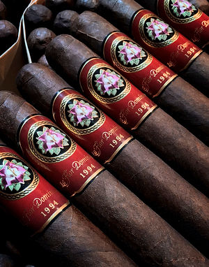 Close-up of La Flor Dominicana 1994 cigars showing red bands with the brand logo and '1994'.